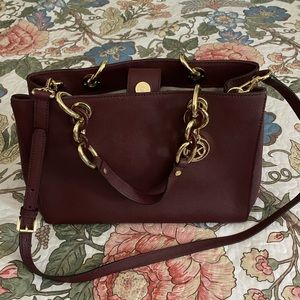 Michael Kors maroon satchel.